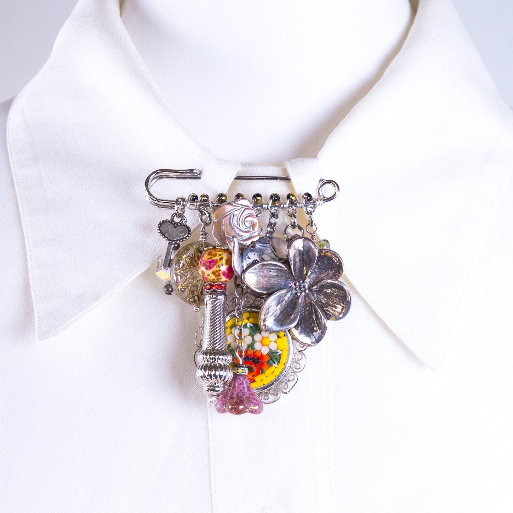 6813756fc324346626b37929_short-stories-charm-brooch-silver-multi-front_1758133813664.jpg